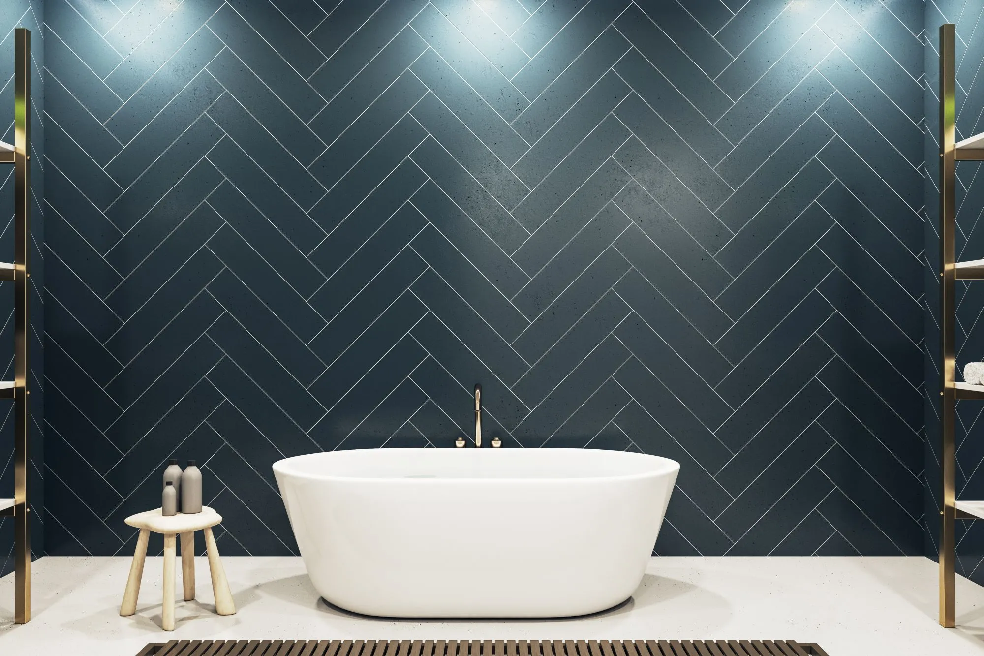 A freestanding white bathtub against a navy blue herringbone tile bathroom wall